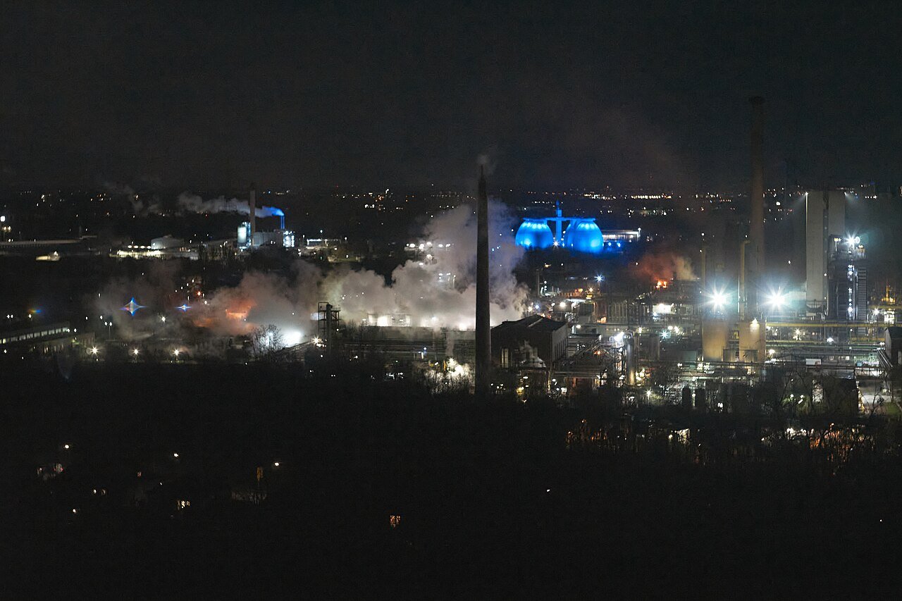 Large industrial coke plant and chemical processing complex with pipework, representing dense downstream process infrastructure