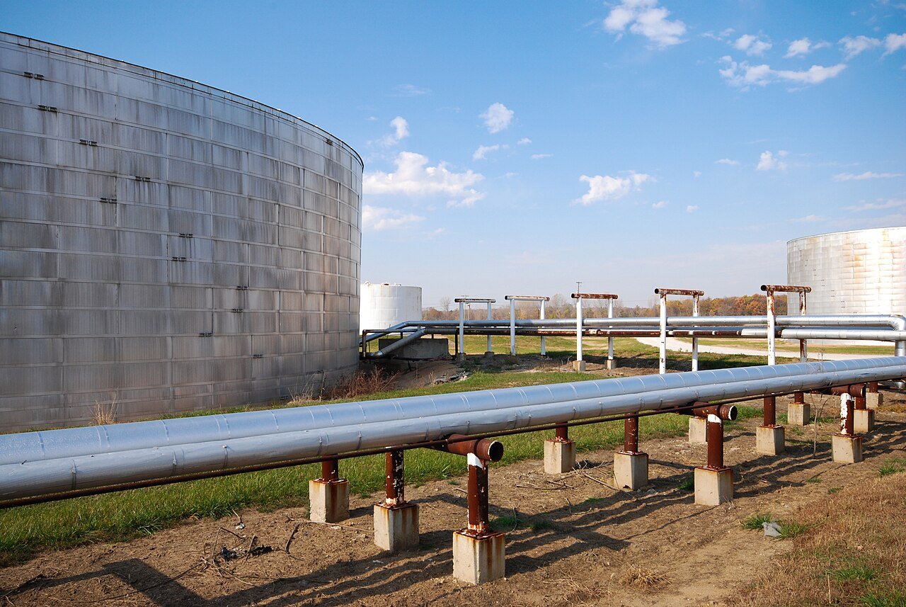 Storage tanks and process piping at a refinery, where online sealing crews work under live operating conditions