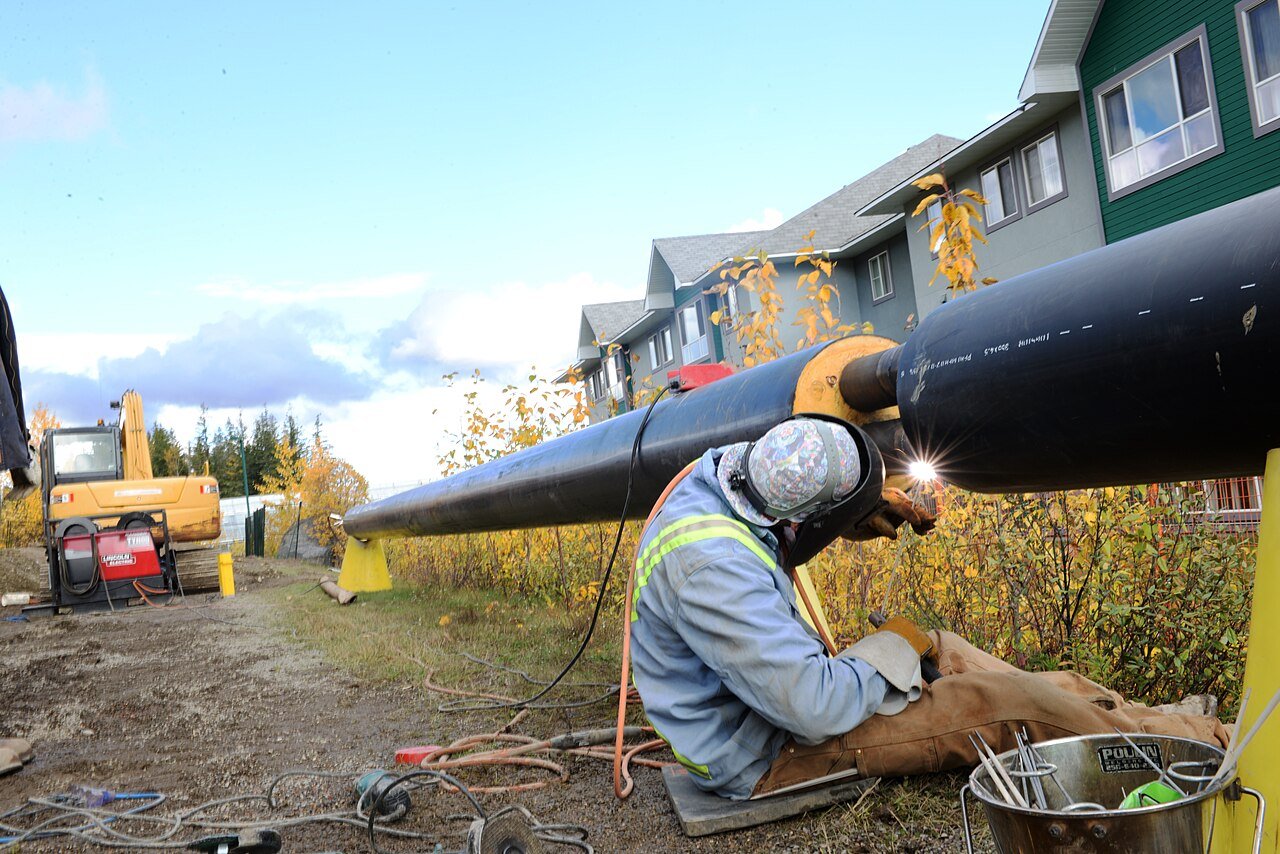 Welder completing a pipe joint on site — field fabrication capability underpins an emergency leak online repair solution in remote Indonesian locations