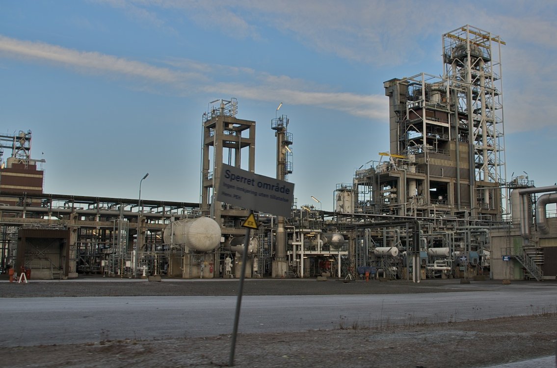 Petrochemical plant with process units lit during night-shift operation, the setting for a 24 hour emergency leak online sealing response
